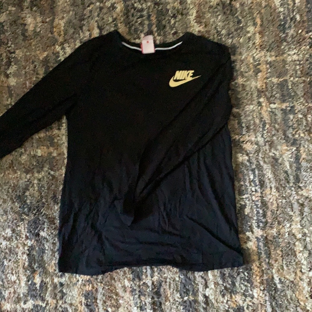 Black nike long sleeved shirt with gold lettering.